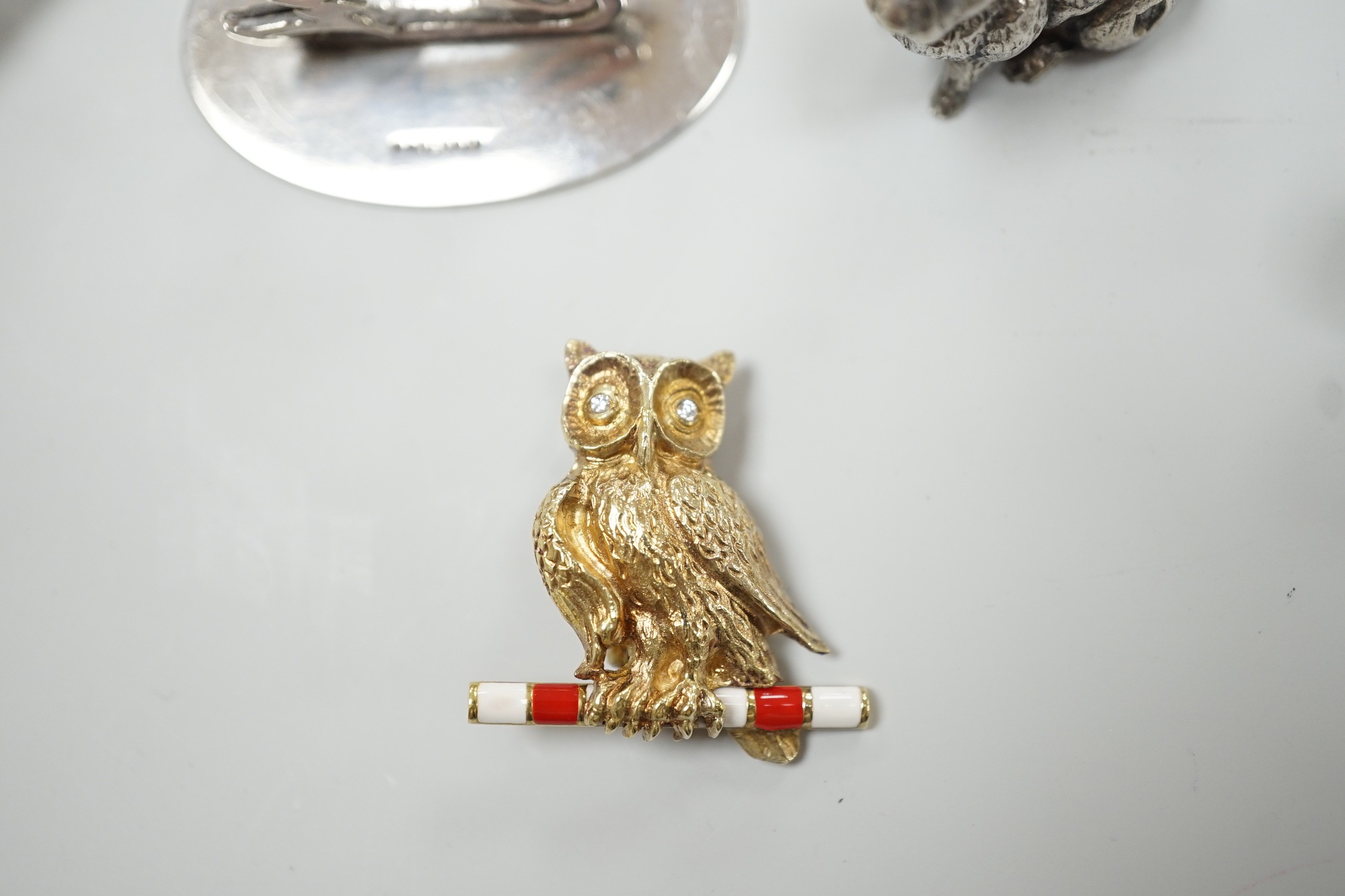 Eight assorted modern silver miniature animal or bird figures including menu holders, including rabbit by Tessiers Ltd, height 27mm, an earlier silver swan menu holder and a silver gilt owl brooch.